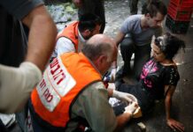 Terrorists deserve justice, not flattering ‘NPR’ profiles Emergency workers and first responders assist a woman at the scene of a Palestinian suicide bombing at the Shuk HaCarmel open-air market in the heart of Tel Aviv, Nov. 1, 2004. Photo by Flash90.